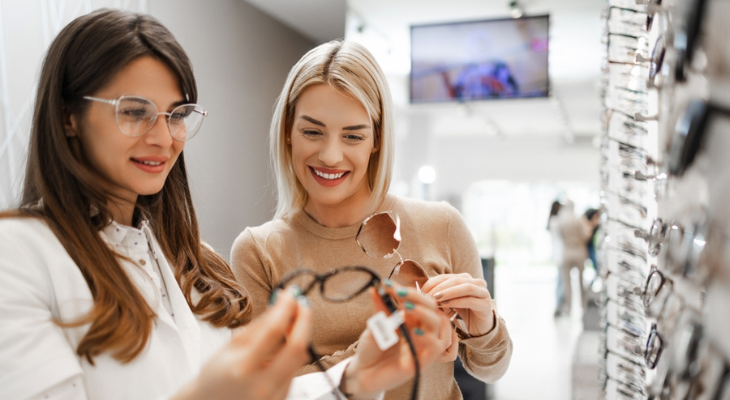 Two women shop for eyeglasses.