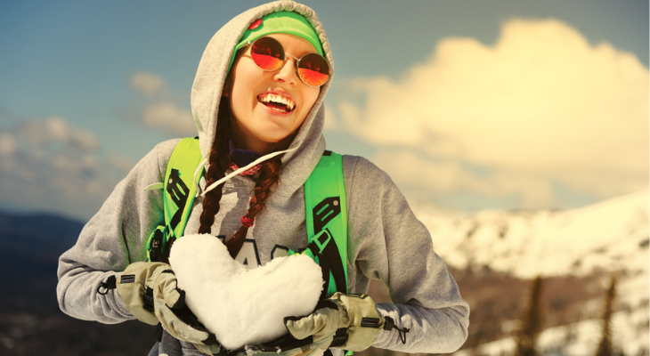 Woman wears sunglasses in winter