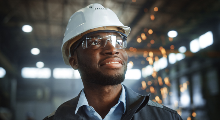Man wears safety glasses on the factory floor.