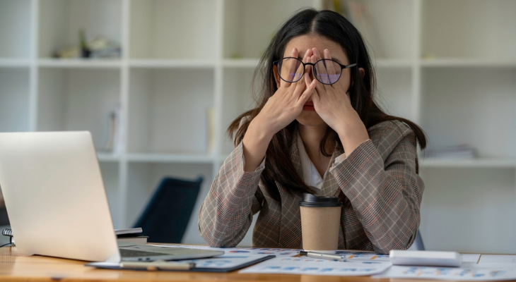 Sleepy woman struggles through her work day.