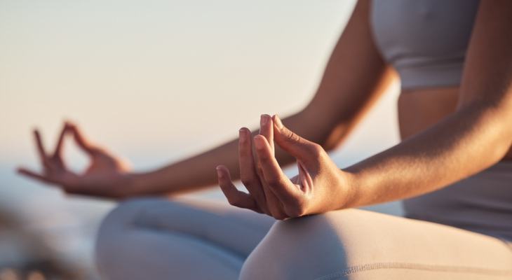 Woman practices mindfulness through yoga.