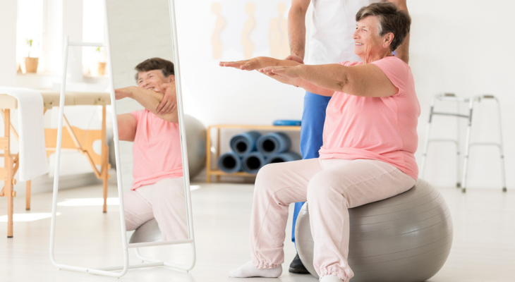 Woman practicing balance on exercise ball