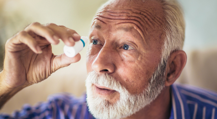 old man uses eye drops