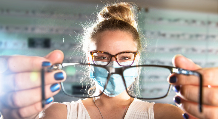 Woman puts glasses on the camera