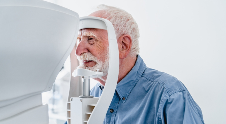 Old man has his eyes examined.