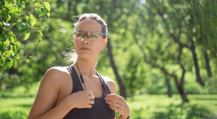 Woman wears sports eyewear while running.