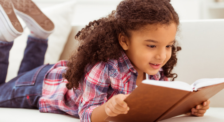 Little girl reading a book