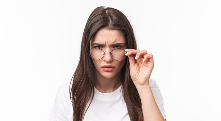 Pretty woman squints at you.