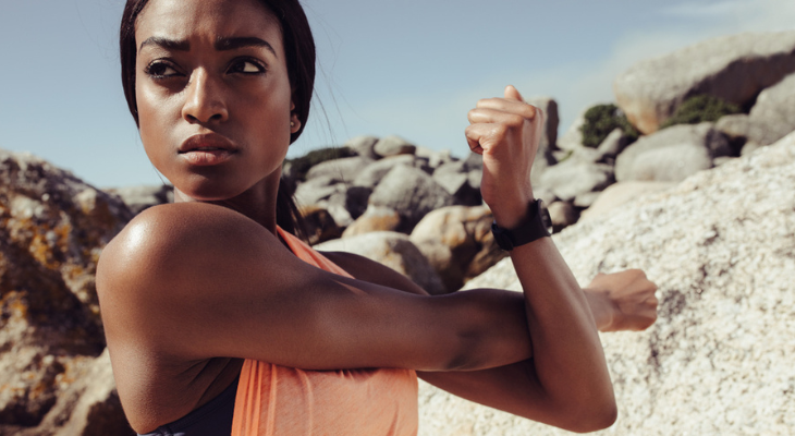 Athletic woman with severe expression stretching.