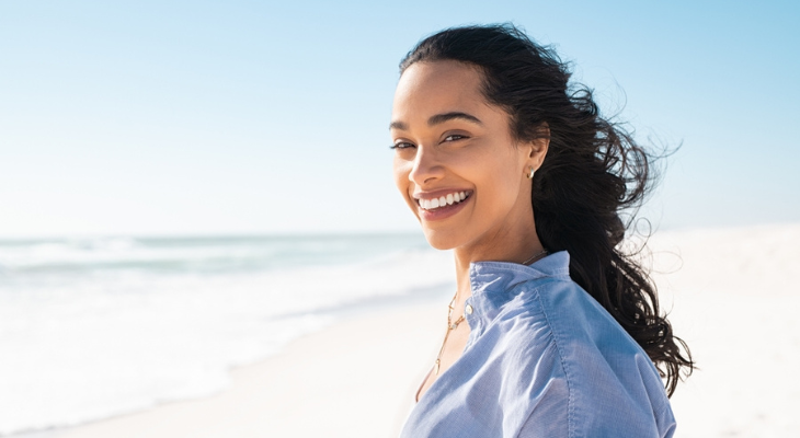 Woman protecting her eyes from the sun with contacts.