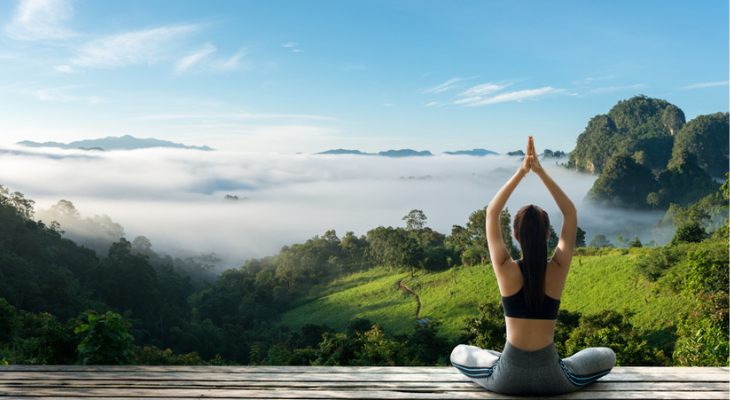 Woman does yoga outside