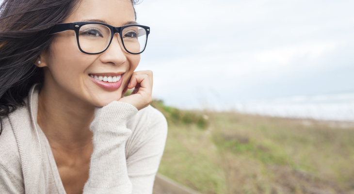 Woman smiles at the ocean. The ocean smiles back.