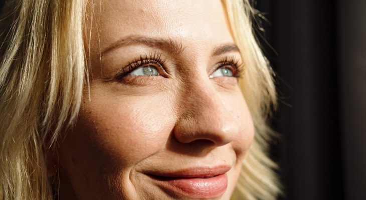 Woman looks up into the light.