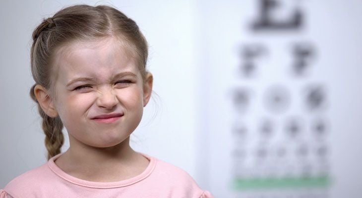 Young girl squinting eyes