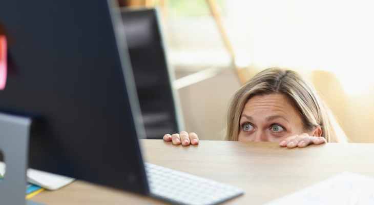 Woman hides from digital eye strain.