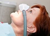 woman with nitrous oxide mask over nose, Conscious sedation dentistry Baton Rouge, LA dentist