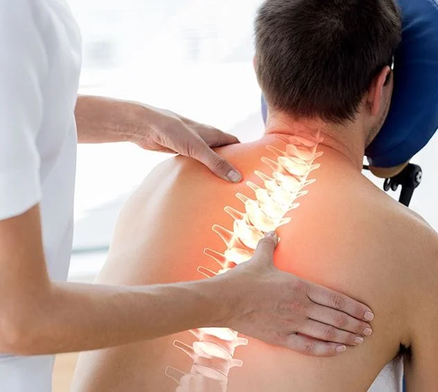 Chiropractor adjusting patient on massage chair with spine illuminated