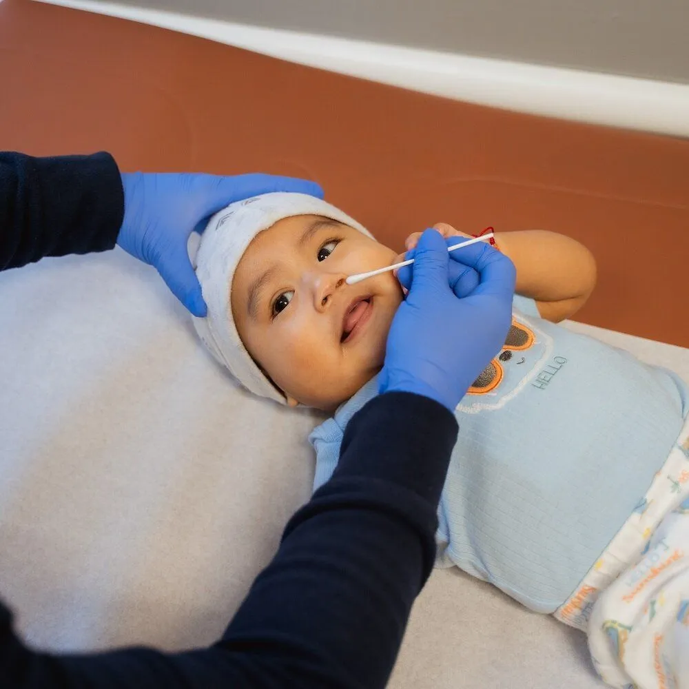 Infant receiving exam