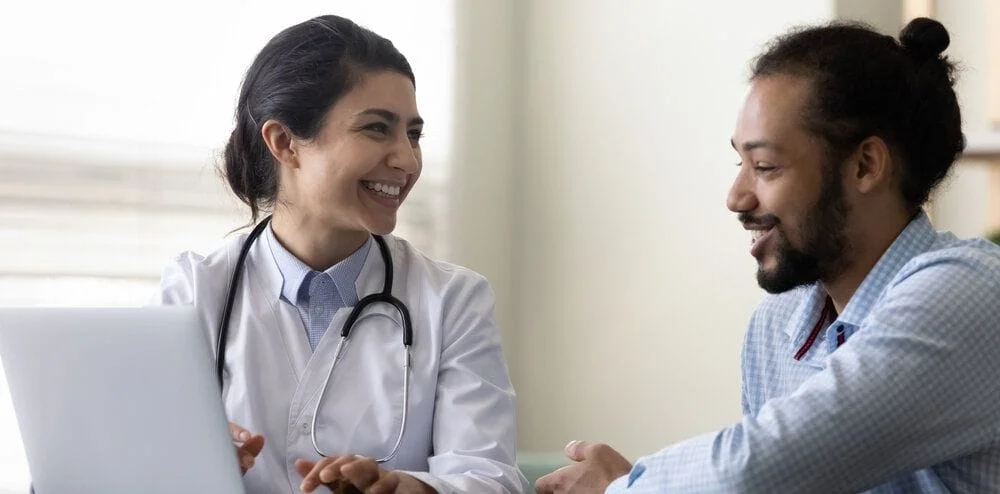 Happy Physician discussing with patient