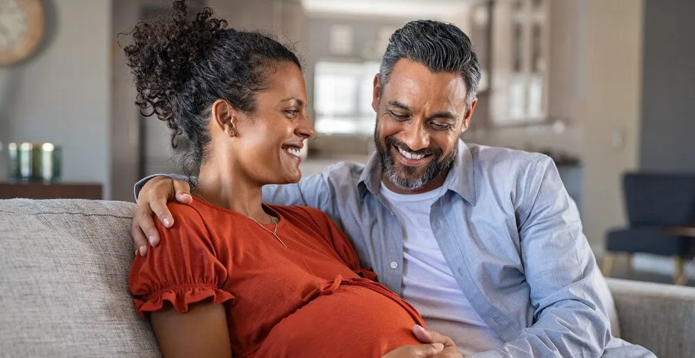 Pregnant woman smiling with man