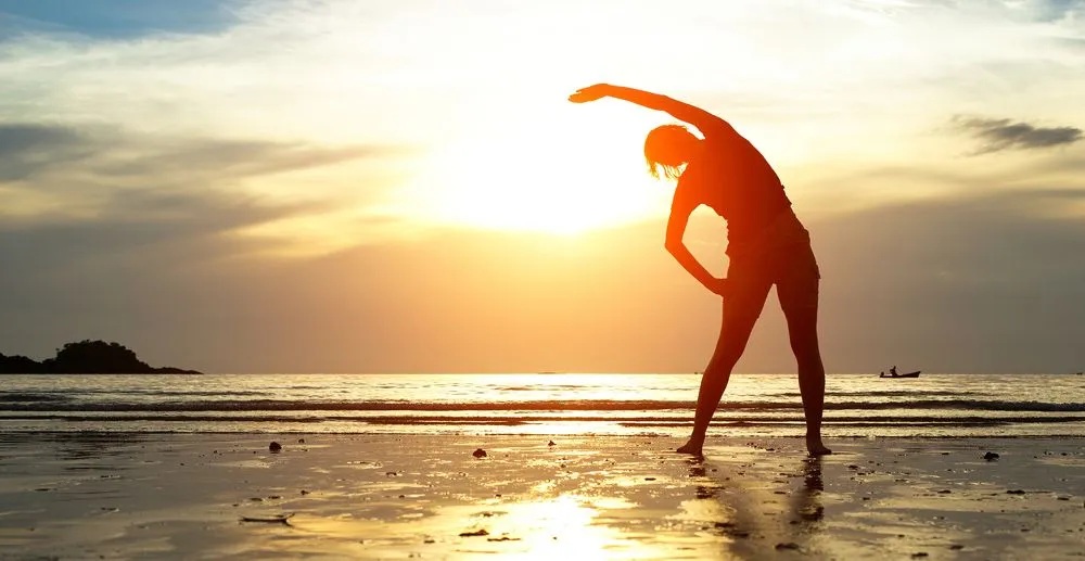 Woman stretching at the beach