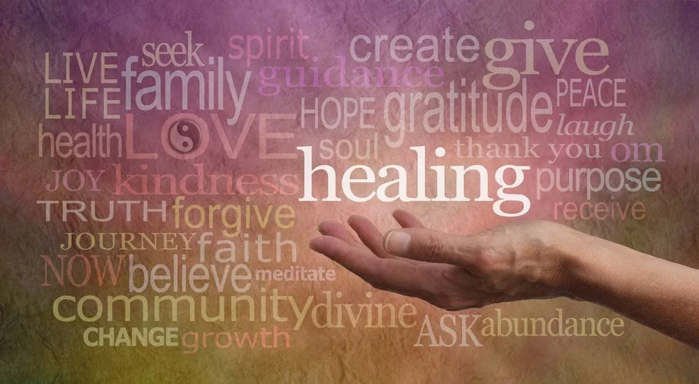 Hand with uplifted palm, holding the word "Healing"