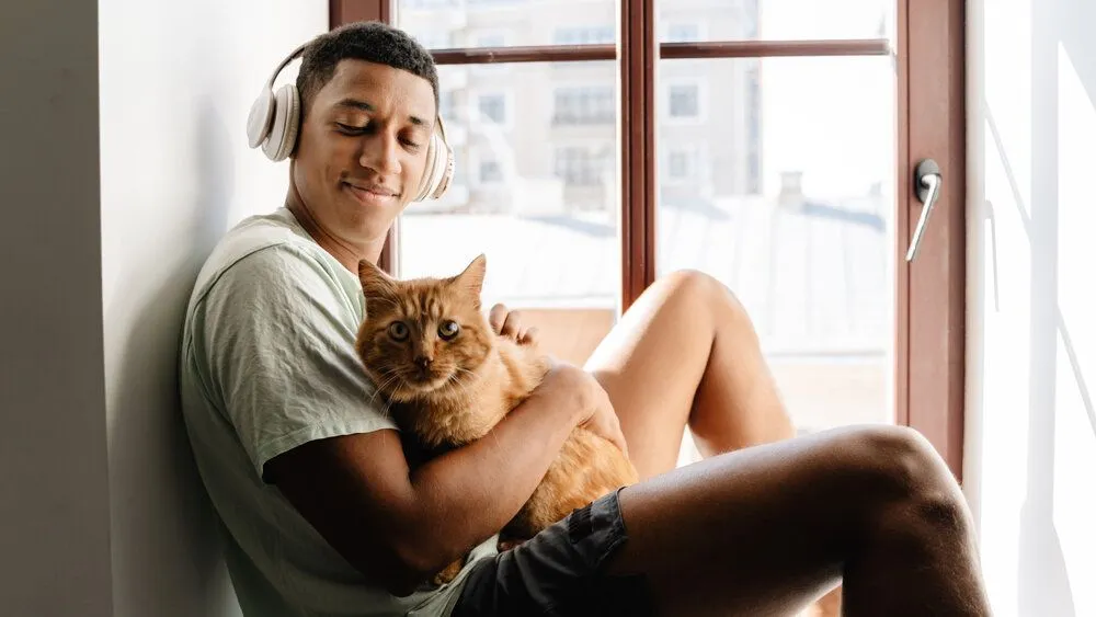 man holding their cat