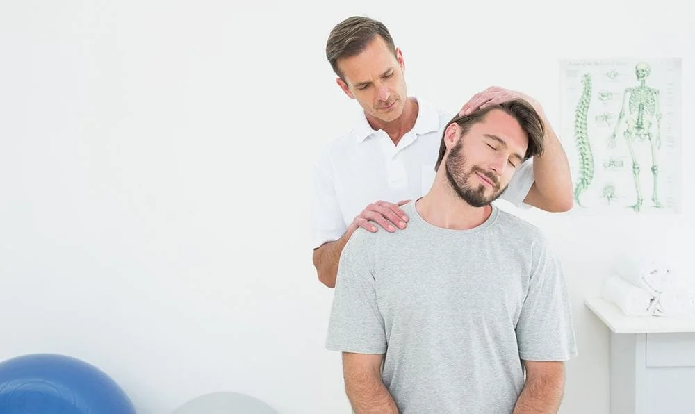 male patient receiving neck pain chiropractic treatment
