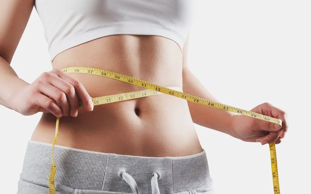 Model using tape measure around waist