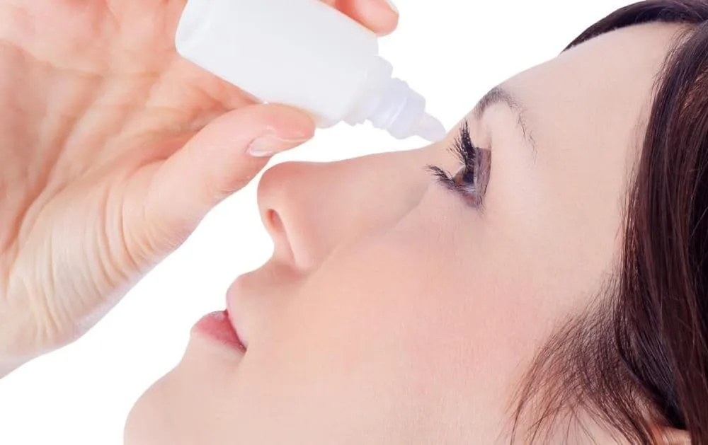 Woman using eye drops for her dry eyes.