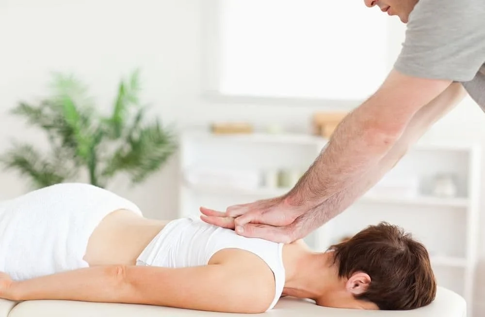 Woman getting a chiropractic adjustment.