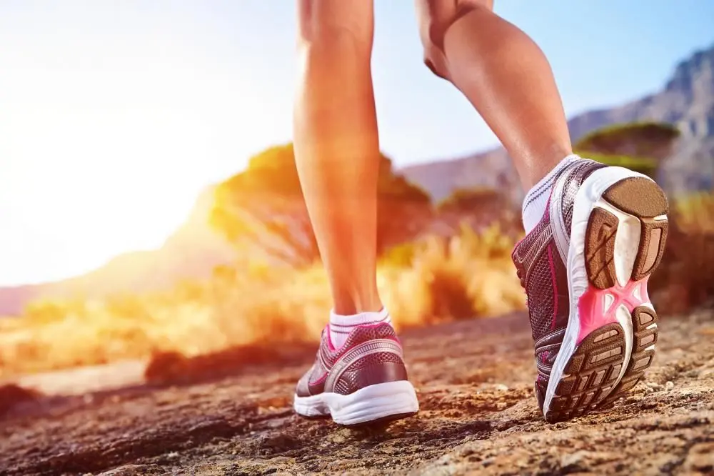 Woman running with healthy Achilles Tendons.