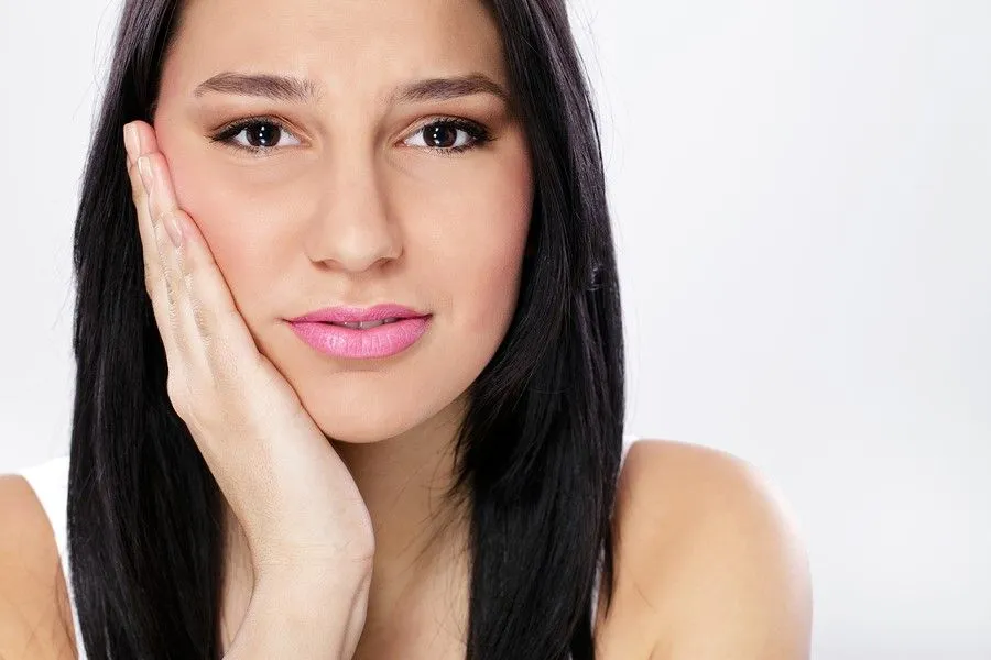 Photo of woman in need of Emergency Dentistry holding her jaw in Winter Garden, FL