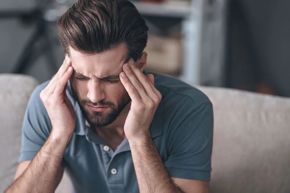 Man with a severeheadache treatment in Kenosha, WI.