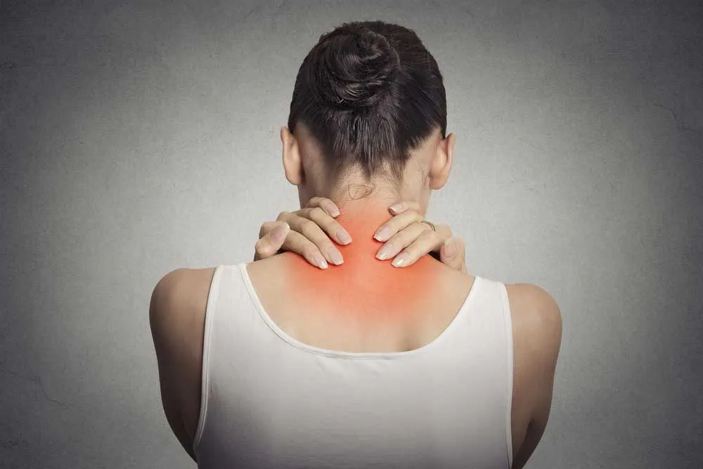 Woman suffering from pinched nerves on neck