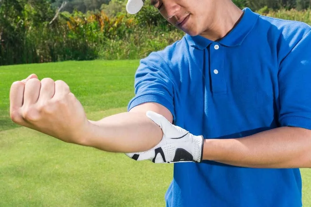 Man suffering from Golfers Elbow