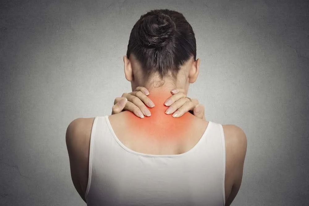 female holding neck in pain
