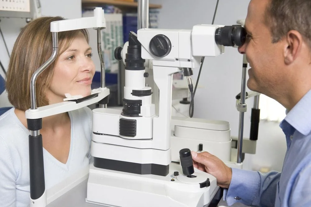 optometrist giving a woman an eye exam