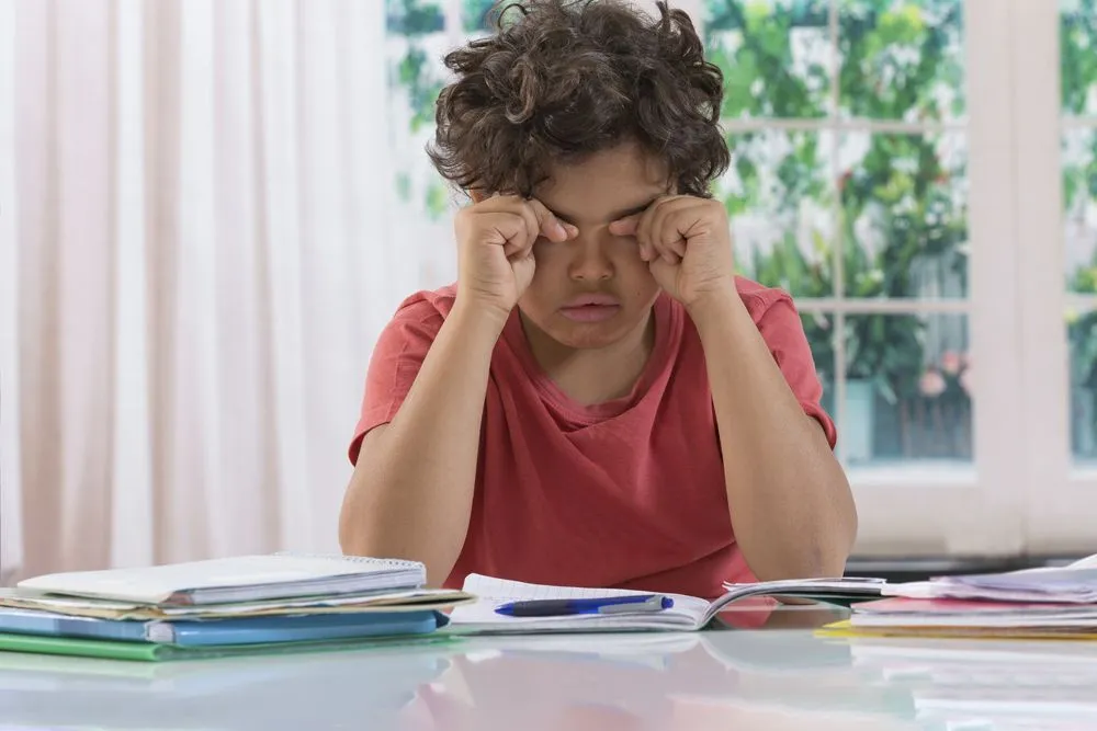 Boy struggling with his homework.