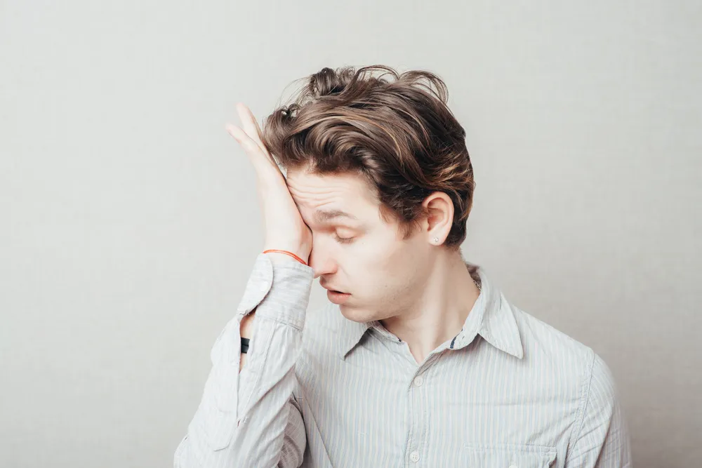 Kid rubbing his eye from his poor daily wear contact lenses