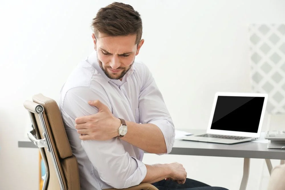 Man with shoulder pain needs chiropractic care in Manhattan, KS.