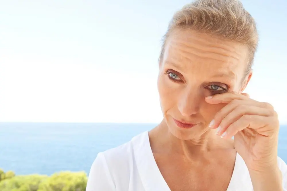 Woman experiencing dry eye outdoors.