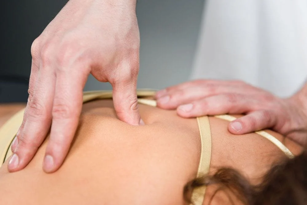Chiropractor giving deep tissue massage to patient