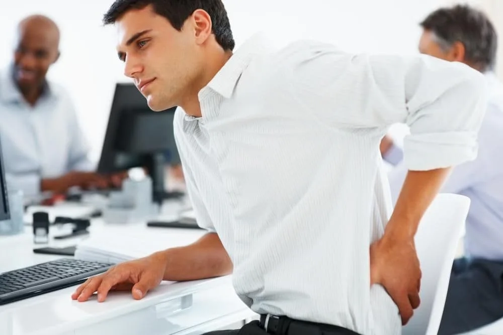man with lower back pain at offce