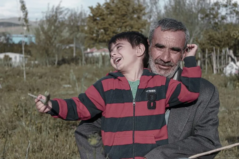 grandfather holding grandson