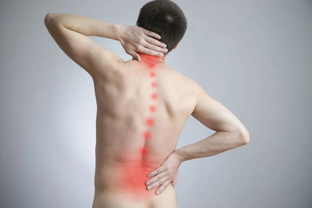 A man holding his bag along with a graphic to indicate pain down his spine