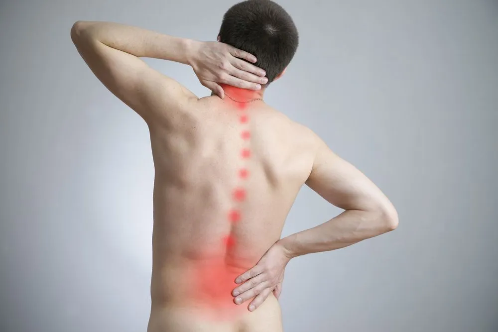 A man holding his bag along with a graphic to indicate pain down his spine