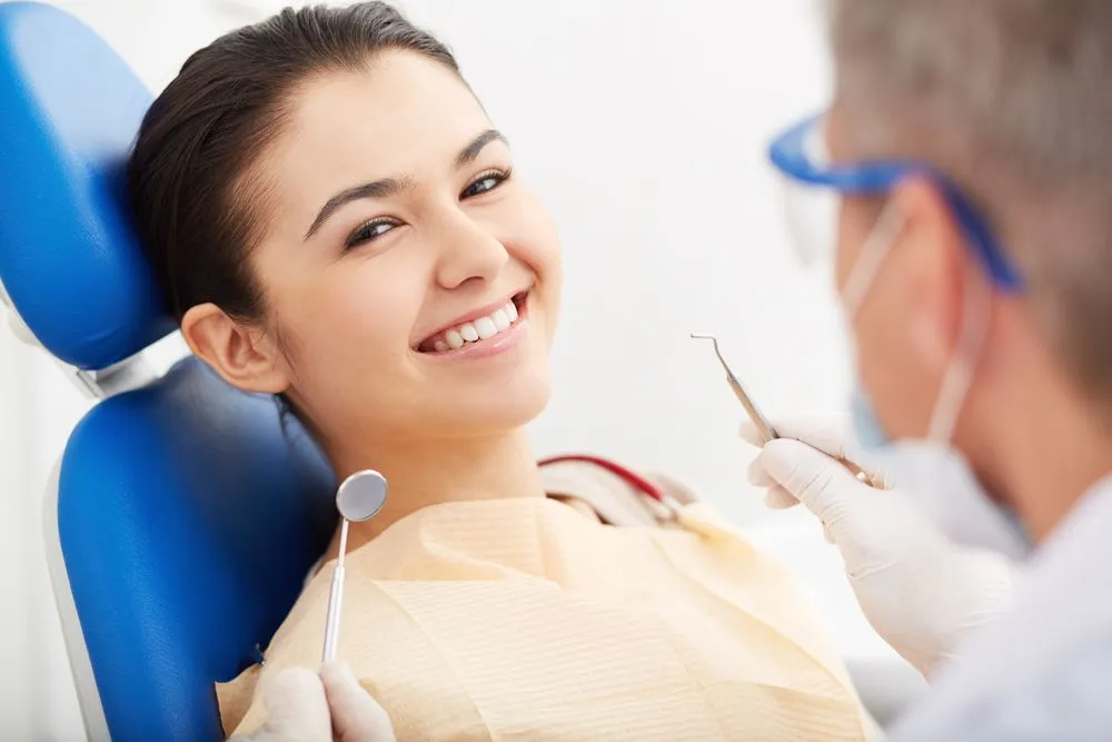 women getting cracked tooth treatment with a dentist in Victorville
