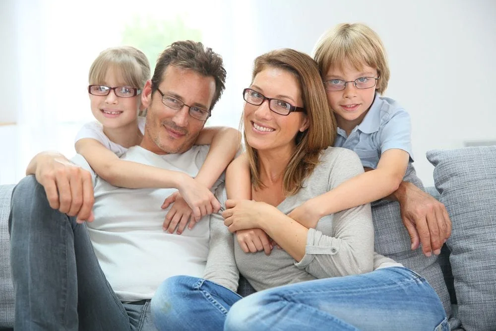 Family wearing prescription eyeglasses
