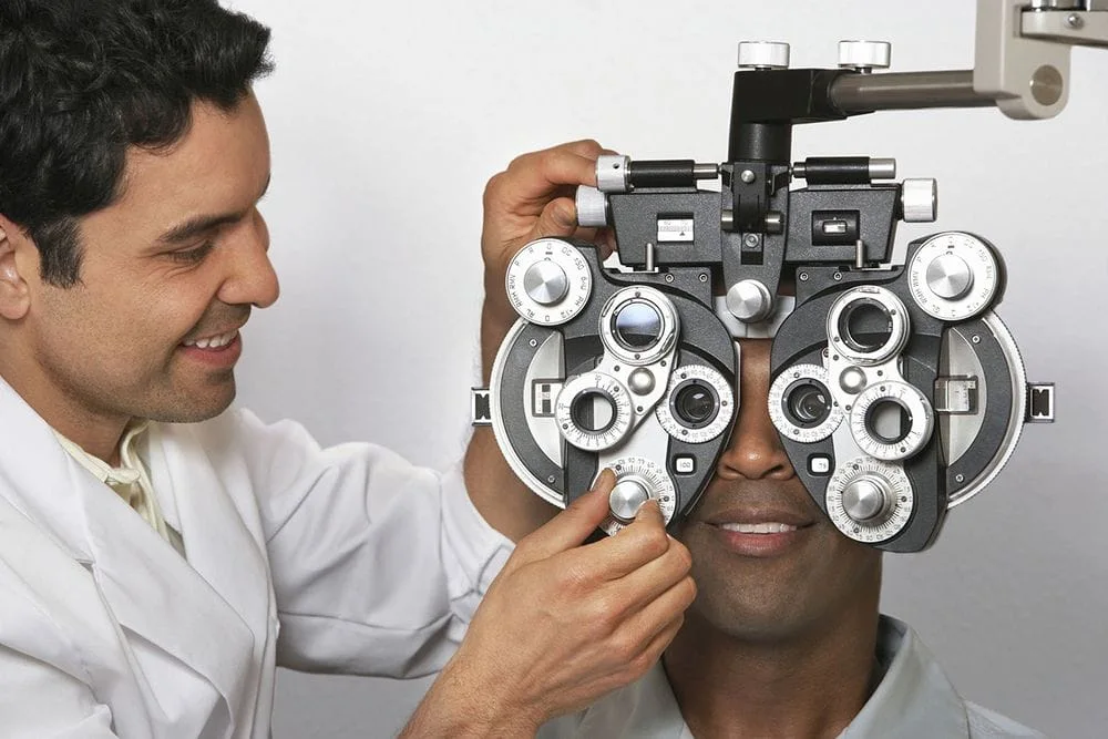 man receiving an eye exam from his optometrist